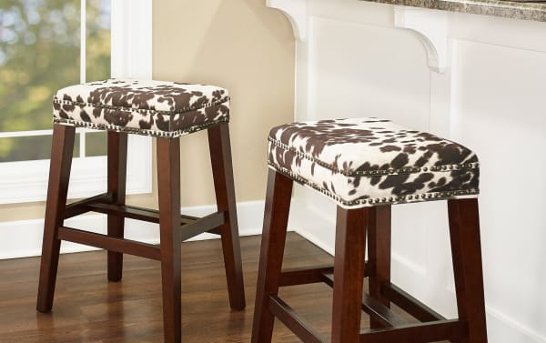 Kristen Cow Print Walnut Backless Bar Height Stool with brown polyester upholstery, silver nailhead trim, and traditional rubberwood frame