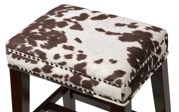 Kristen Cow Print Walnut Backless Upholstered Counter Height Stool with brown and white polyester fabric, walnut-finished rubberwood legs, and silver nailhead trim.