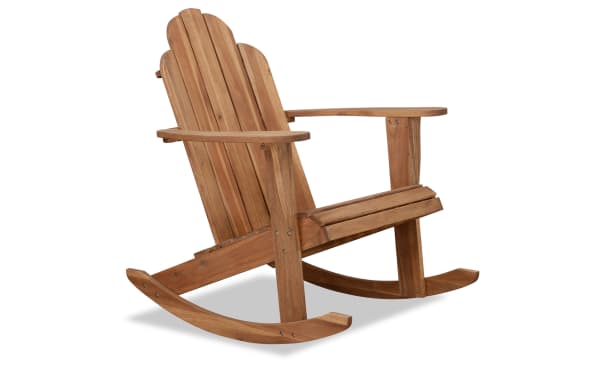 Traditional Joan Brown solid Acacia wood outdoor Adirondack rocker chair with high slatted back, wide armrests, and teak finish for patio or porch.