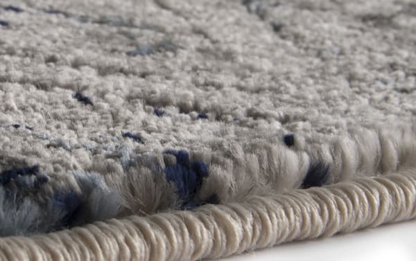 Close-up of the Casablanca 8' x 10' Gray Vintage Rug edge, showing thick, soft polypropylene yarn in multicolored transitional style with gray and blue tones.