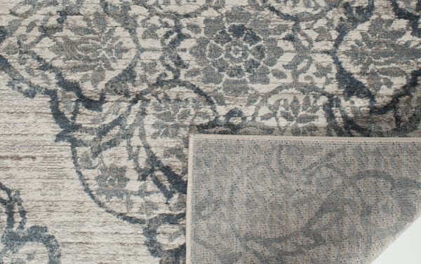 Lilah 5' x 7' Blue Damask Rug with intricate damask pattern in blue tones, made of durable polypropylene and polyester fabric, transitional style.