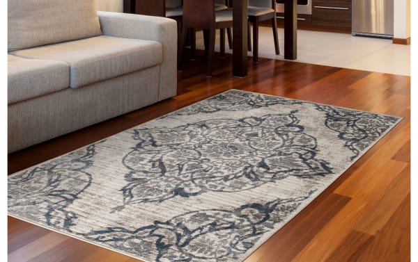 Lilah 5' x 7' Blue Damask Rug with intricate blue and gray damask pattern, made of durable polyester and polypropylene, transitional style.
