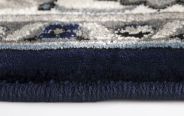 Close-up of the Willow 5' x 8' White Oriental Rug edge, showing dense blue and white polypropylene fibers in a traditional oriental pattern.