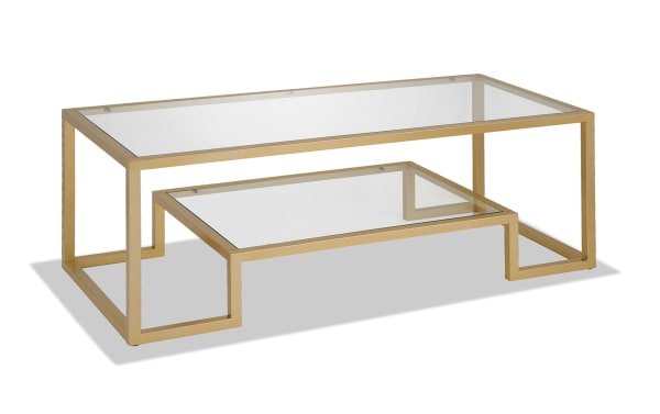 Hurley Gold Coffee Table with glam style, featuring a gold steel geometric frame and clear tempered glass top and lower shelf for a modern look.