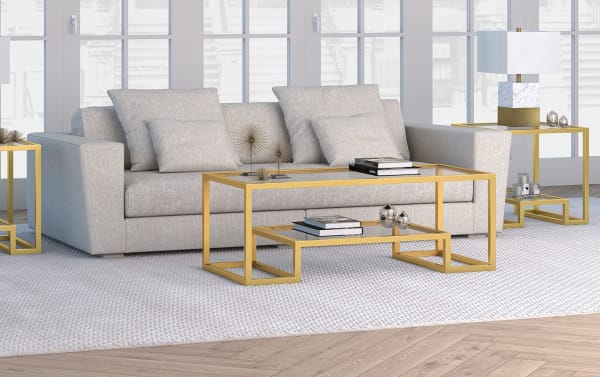 Hurley Gold Coffee Table with tempered glass top and shelf, gold geometric steel frame, glam style for a modern living room centerpiece.