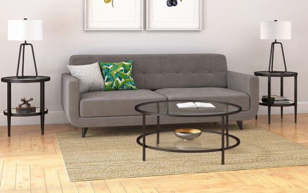 Contemporary Linda Blackened Bronze Round Coffee Table with tempered glass top and bottom shelf, hand-finished steel frame, ideal for modern living rooms.