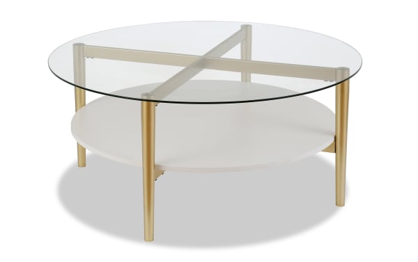 Connor White Round Coffee Table with mid-century modern style, featuring a clear tempered glass top, white lower shelf, and gold tapered steel legs with hand-crafted finish.
