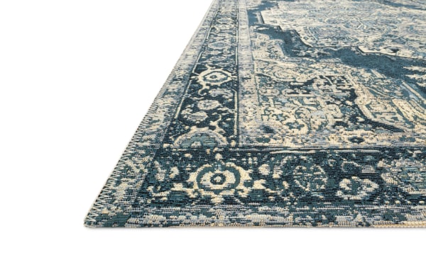 Navy Oriental indoor/outdoor runner rug, 2' x 7', with traditional floral patterns in navy, light blue, ivory, and silver. Polypropylene fabric.