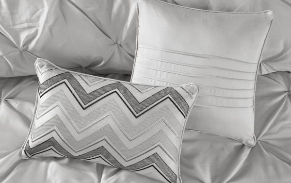 Contemporary Alan Queen Gray Solid 24 Piece Comforter Set with gray polyester fabric, featuring textured and patterned accent pillows on a tufted comforter.