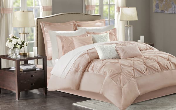 Alan Queen Blush Solid 24 Piece Comforter Set in blush and white polyester fabric, featuring a contemporary quilted comforter, multiple pillows, shams, sheets, bed skirt, and window treatments for a complete bedroom makeover.