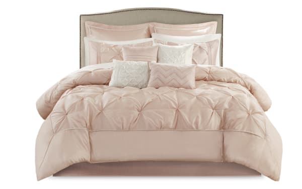 Alan Queen Blush Solid 24 Piece Comforter Set in blush and white polyester fabric, featuring a contemporary tufted comforter, multiple decorative pillows, shams, sheets, and window treatments for a complete bedroom makeover.