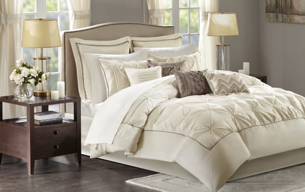 Alan Queen Ivory Solid 24 Piece Comforter Set in contemporary beige and brown polyester fabric, featuring a plush comforter, multiple decorative pillows, Euro and standard shams, sheets, bed skirt, window valances, and tiebacks for a complete bedroom makeover.