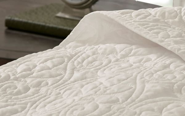 Wayn Twin Cream Solid 2 Piece Bedspread Set in cream microfiber and cotton, featuring a transitional style with intricate embroidered quilting and a matching sham.