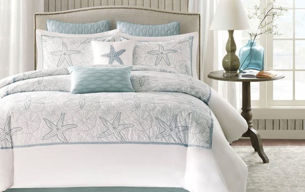 White cotton Play Queen White Coastal 4 Piece Comforter Set with quilted starfish and seashell patterns, including shams and bed skirt in traditional coastal style