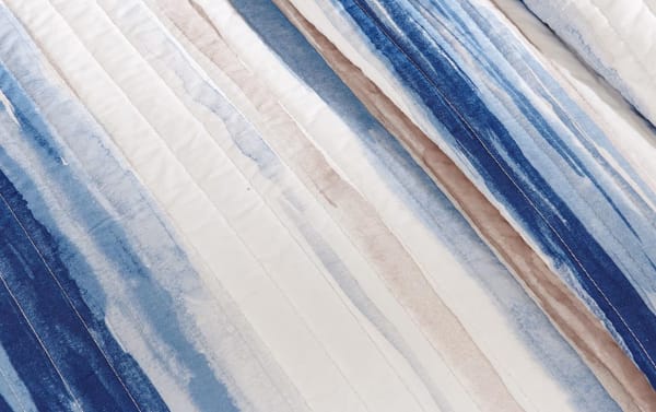 Lucas Full/Queen Blue 6 Piece Coverlet Set with quilted accent pillows, shams, and striped reversible cotton-polyester coverlet in blue, navy, taupe, and cream.