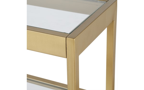 Contemporary Alexa 55" Brass Console Table with gold metal frame and tempered glass top, featuring clean lines and open shelf design.