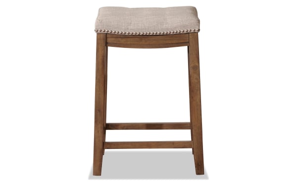 Ryann Gray Backless Upholstered Counter Height Stool with rustic rubberwood frame, gray linen fabric seat, and silver nailhead trim, transitional style.