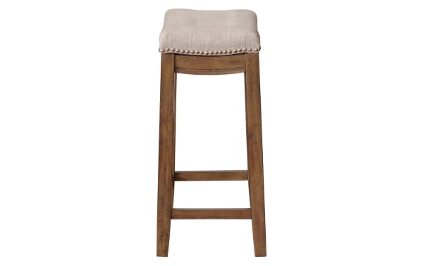 Ryann Gray Backless Upholstered Counter Height Stool with rustic rubberwood frame, gray linen fabric seat, and silver nailhead trim, transitional style.