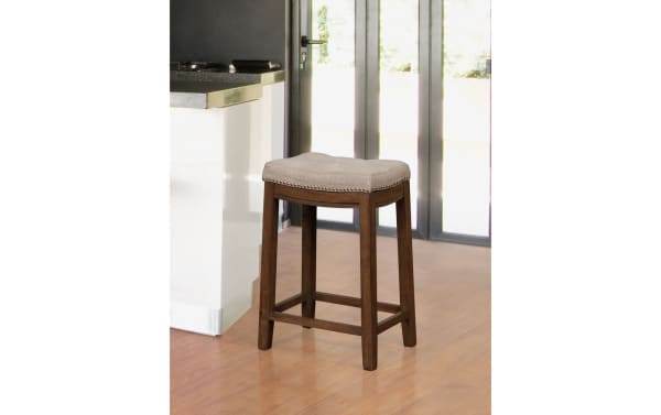Ryann Gray Backless Upholstered Counter Height Stool with gray linen fabric seat, rubberwood frame, rustic finish, and silver nailhead trim.