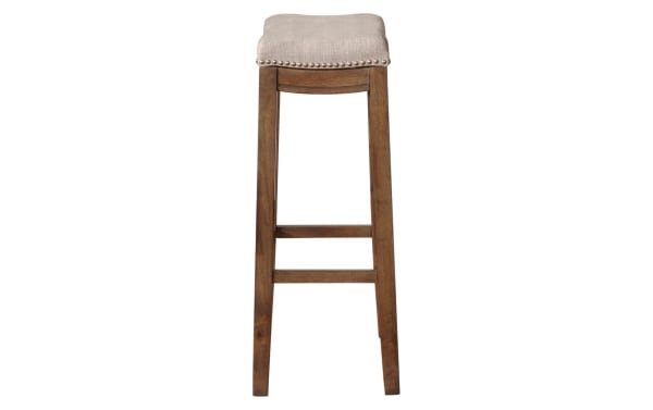 Ryann Gray Upholstered Backless Bar Height Stool with gray linen fabric seat, brushed silver nailhead trim, and rustic rubberwood frame.