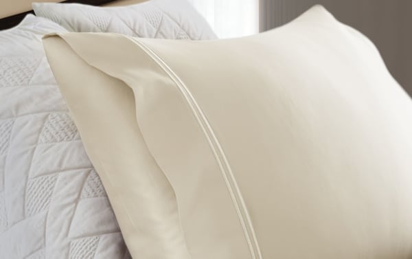 Traditional white pillowcases from MyBob's Full White Solid Premium Modal 4 Piece Sheet Set, made of soft modal and cotton blend with a smooth sateen finish.