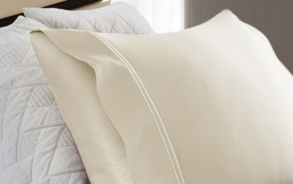 Cream-colored pillowcases from MyBob's Premium Modal 4 Piece Sheet Set, featuring smooth, soft modal and cotton blend with a traditional style and double-stitched edges.