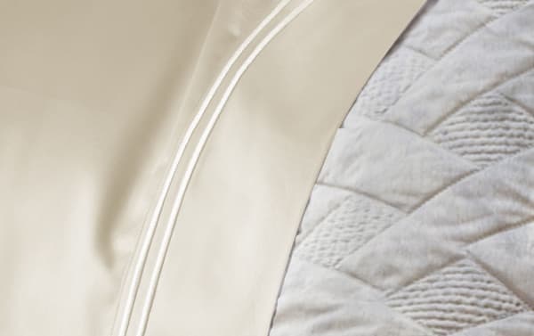 Close-up of beige MyBob's Premium Modal 4 Piece Sheet Set showing smooth sateen weave, double-stitched hem, and modal-cotton blend fabric.