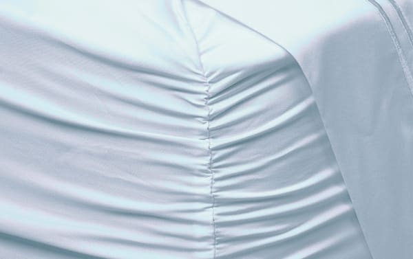 Light blue MyBob's Split Head Queen sheet set made of premium modal and cotton blend with ruched fitted sheet for secure mattress fit.
