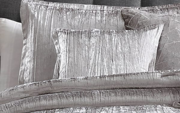 Zoey Queen Silver Solid 7 Piece Comforter Set with crinkled velvet polyester fabric, includes comforter, shams, bedskirt, and accent pillows in a transitional silver style.