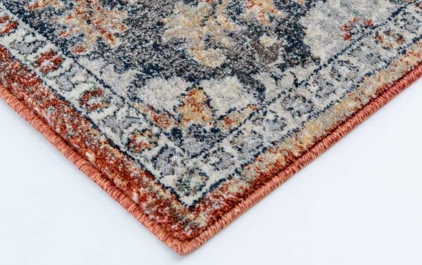 Corner close-up of the Alex 8' x 10' Brown Floral Rug showing its transitional style with brown, gray, red, and orange floral pattern in stain-resistant polypropylene.