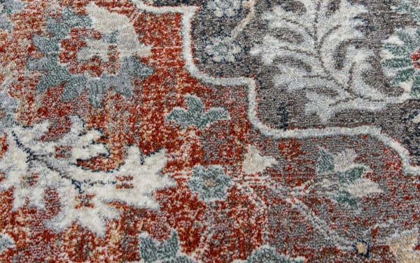 Transitional Alex 8' x 10' brown floral rug in stain-resistant polypropylene with intricate red, gray, and orange pattern accents.