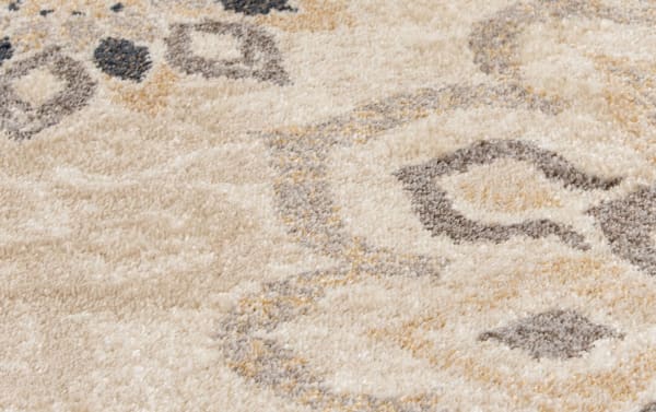Beige Anna 5' x 7' floral rug with ivory and gray transitional design, made of stain-resistant polypropylene for durable home décor.