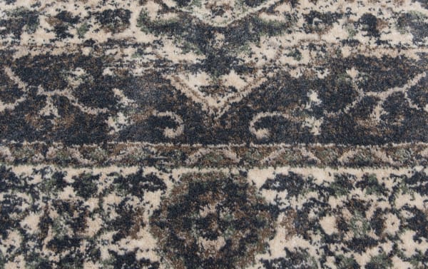 Close-up of the Anny 5' x 7' Blue Traditional Rug showcasing its intricate oriental pattern in blue and ivory hues, made of durable, stain- and fade-resistant polypropylene with a transitional style.