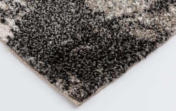 Transitional Rave 5' x 7' Ivory Abstract Rug with cream, black, and beige polypropylene fibers, featuring a textured, earthy-toned abstract pattern.