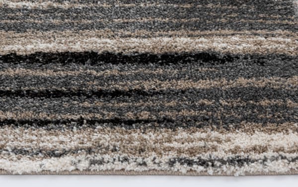 Transitional Bay 5' x 7' Gray Abstract Rug with durable, stain-resistant polypropylene featuring a modern striped pattern in gray, black, and taupe.