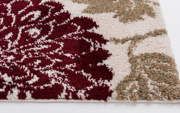 Transitional Carn 5' x 7' Ivory Floral Rug with plush polypropylene fibers, featuring a multicolored floral pattern in red, ivory, and muted orange tones.