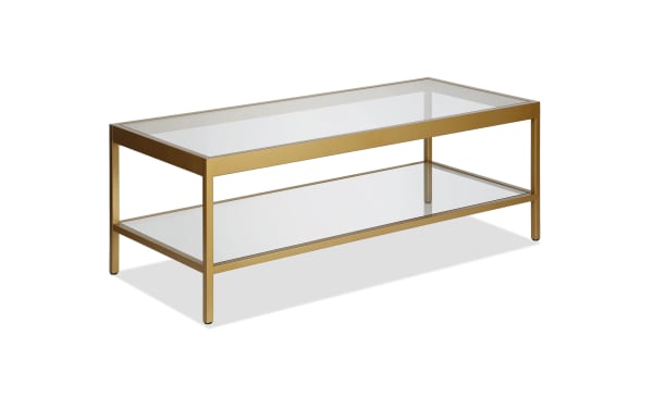 Alexa Brass Coffee Table from the Alexa collection, featuring a contemporary hand-crafted brass steel frame with tempered glass top and lower glass shelf for stylish storage.