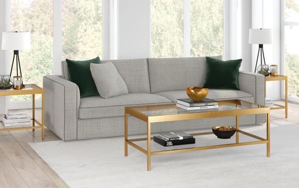 Contemporary Alexa Brass Coffee Table with tempered glass top and shelf, hand-crafted gold steel frame, sleek minimalist design for stylish living rooms.