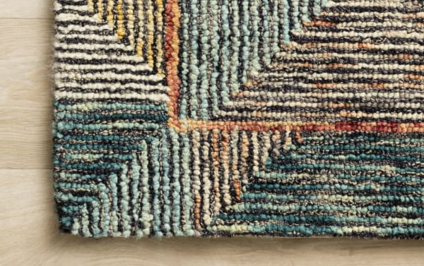 Close-up of Anara 5' x 8' Blue Geometric Rug showcasing hooked wool texture in multicolored blue, olive, gold, and dark espresso geometric patterns.