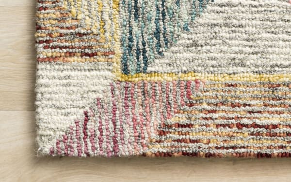 Close-up of Anara 5' x 8' Red Geometric Rug showing multicolored wool texture with pink, berry, gray, blue, gold, and orange geometric patterns in contemporary style.