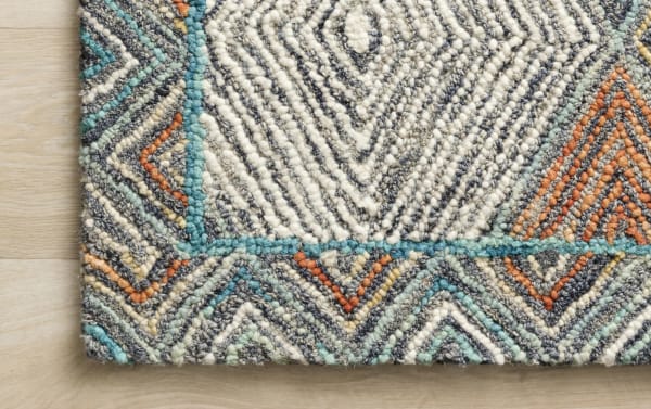 Contemporary Katyusha 5' x 8' Blue Geometric Rug with hand-crafted wool, featuring vibrant multicolored diamond patterns in blue, gray, ivory, and red tones.