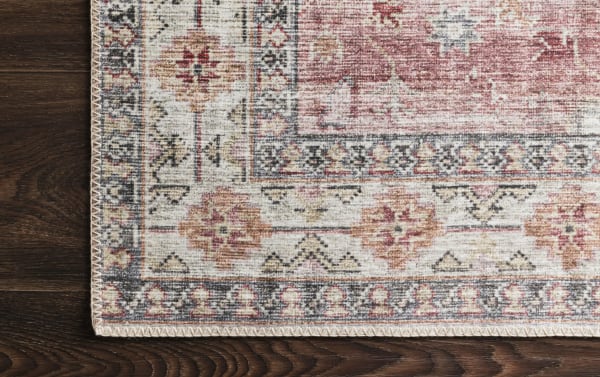 Corner detail of the Lyudmila 5' x 8' Ivory Oriental Rug showcasing traditional old-world design in multicolored polyester fabric with ivory, berry, blush, and charcoal tones on a power-loomed texture.