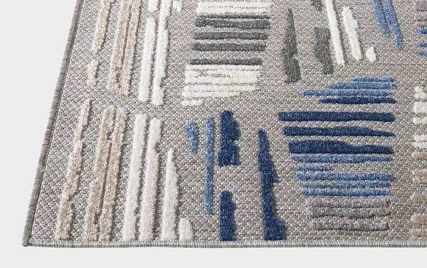 Cardoze 2' x 3' gray geometric rug with blue, taupe, and charcoal accents in a transitional style. Made of stain-resistant polypropylene with a unique high-low woven texture for depth and durability. Ideal for modern homes and high-traffic areas.