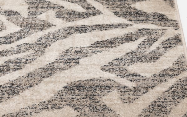Transitional Hadid 5' x 7' gray and cream animal print rug in soft, durable polypropylene, featuring a modern jungle-inspired pattern.