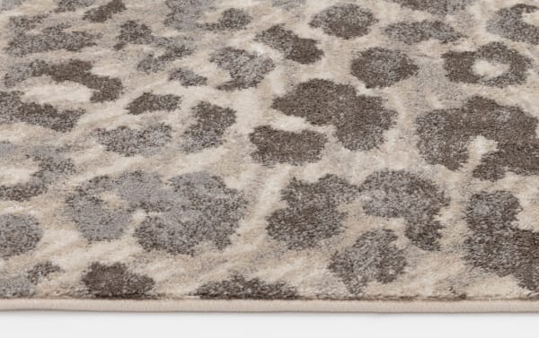 Sharma 8' x 10' gray animal print rug with cream and brown spots, transitional style, made of durable, stain-resistant polypropylene fibers.
