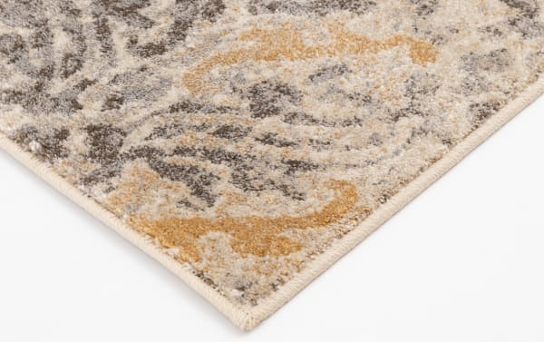 Corner close-up of the Morall 2' x 8' Gray Ikat Runner showing its intricate transitional ikat pattern in gray, cream, and yellow polypropylene fibers with a tightly woven edge for durability and fade resistance.