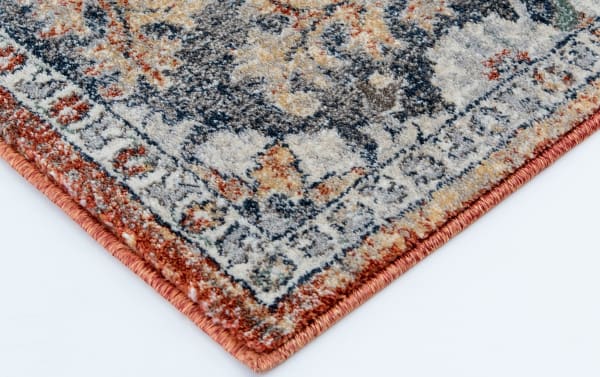 Corner close-up of the Tamin 6' x 9' Multi Oriental Rug showing its transitional style with blue, red, yellow, cream, orange, and gray hues, made of durable, stain-resistant polypropylene yarn with a detailed woven border.