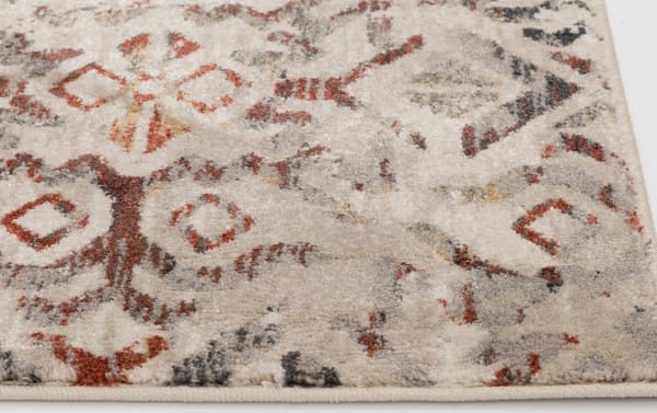 Beige Solis 3' x 5' Ikat rug with cream, red, blue, orange, and yellow tones in a transitional faded vintage pattern. Made of durable polypropylene.