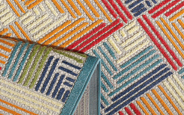 Tae 5' x 7' multi geometric indoor/outdoor rug in blue, cream, orange, red, green, and purple. Transitional style polypropylene fibers, stain and fade resistant.