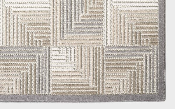 Beige Tae 2' x 3' indoor/outdoor rug with abstract geometric pattern in cream, gray, brown, and taupe. Durable polypropylene fibers, stain and fade resistant, transitional style.